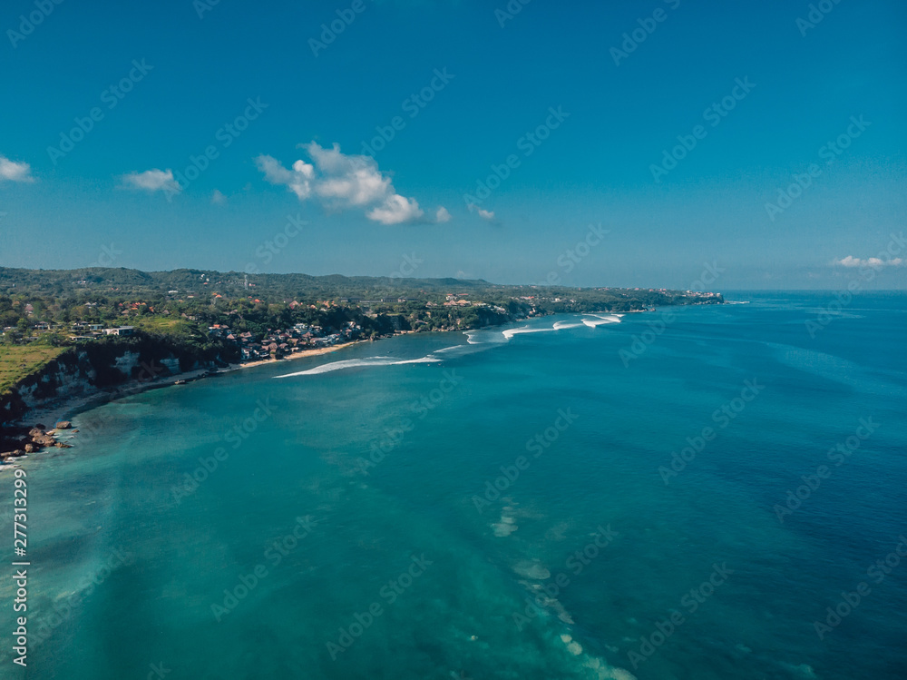 Aerial view of coastline with tropical beach and blue ocean in Bali Aerial view of coastline with tropical beach and blue ocean in Bali