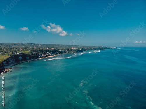 Aerial view of coastline with tropical beach and blue ocean in Bali