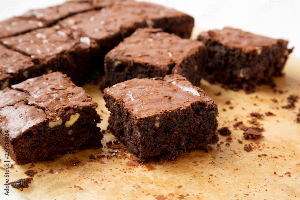 Freshly baked chocolate brownies on a baking sheet, side view. Close-up. Freshly baked chocolate brownies on a baking sheet, side view. Close-up.