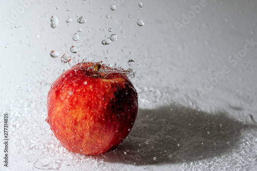 Red apple and splasing water. photo