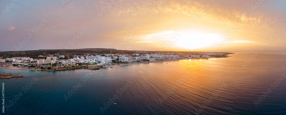 Fototapeta premium Aerial drone shot of Protaras city at sunset