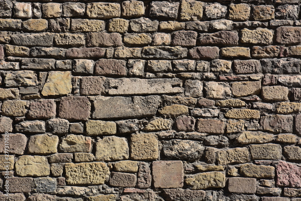 Fototapeta premium wall made of irregular reddish stones