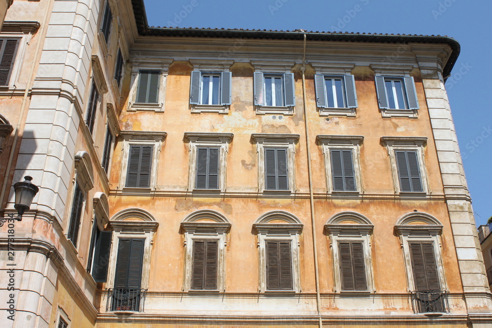 Traditional facade of European architecture with windows and blinds