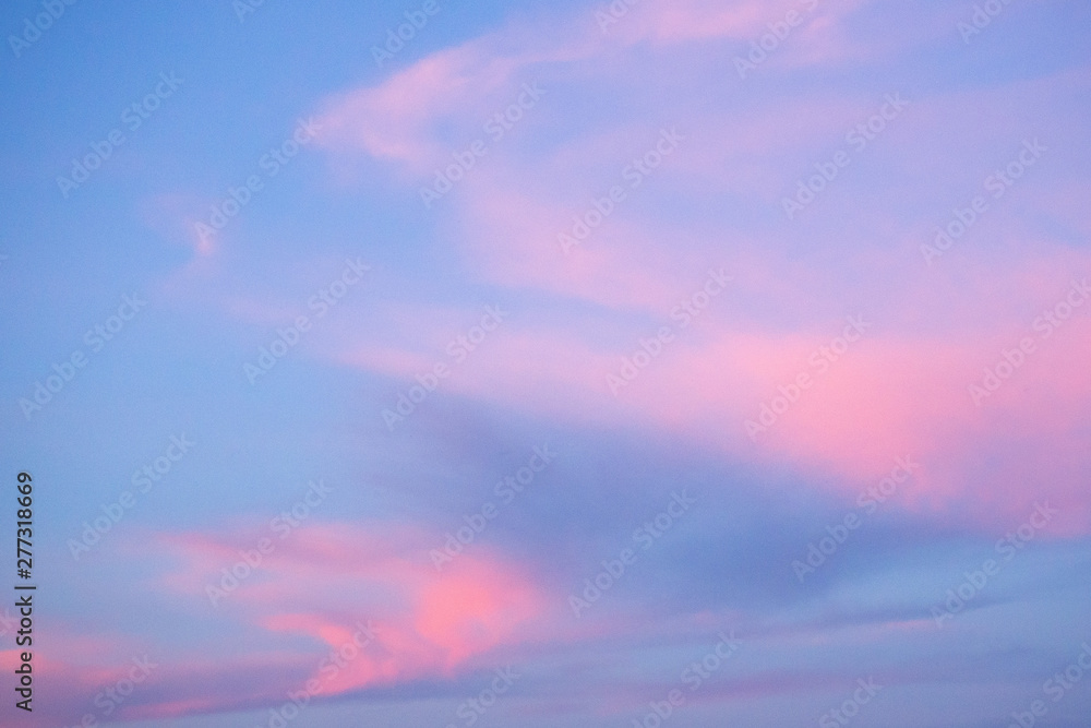 Blue sky and pink clouds. Sunset. Abstract background.