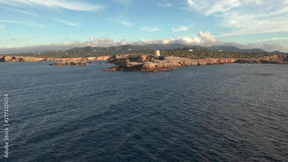 Ibiza pirate tower from a distance. Aerial view moving towards the tower showing the surroundings. Ibiza pirate tower from a distance. Aerial view moving towards the tower showing the surroundings.