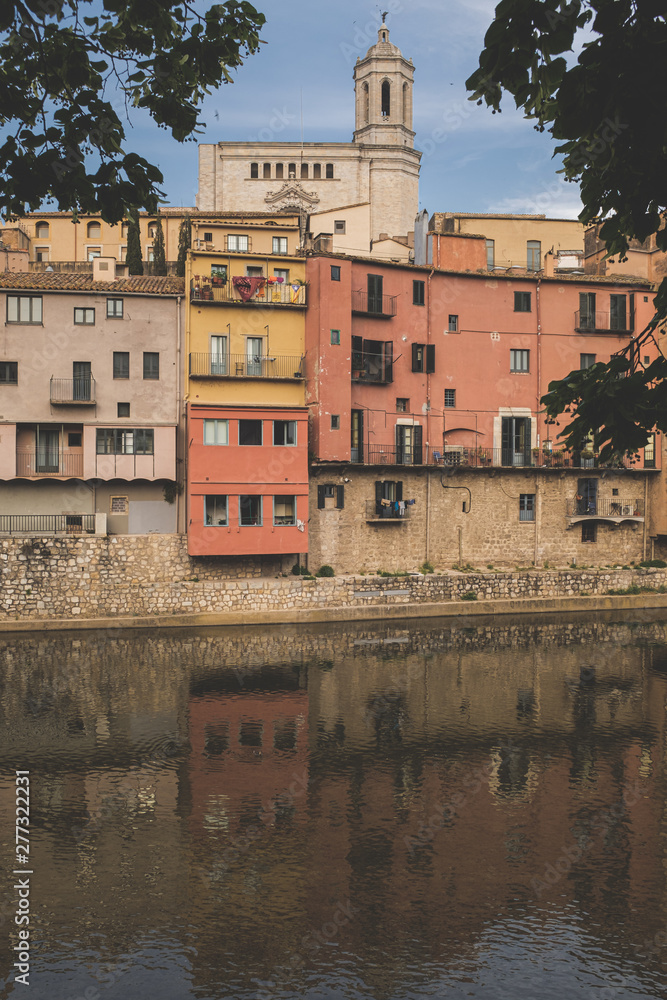 Girona's cityscape with famous river houses reflected in the rover landmark 