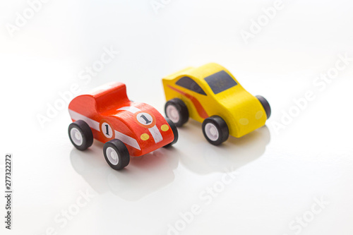 Colourful toy wooden cars on a white background