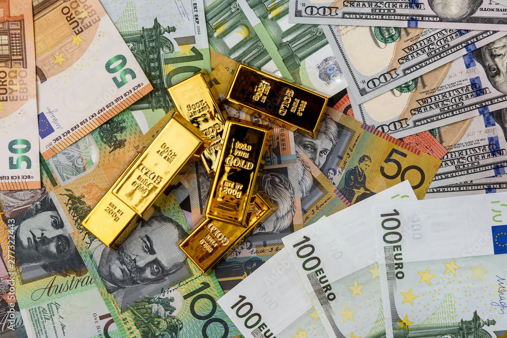Gold ingots on american, australian dollars and euro