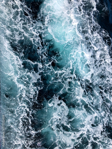 Background shot of aqua sea water surface, Rough sea close up ocean texture wave top view 