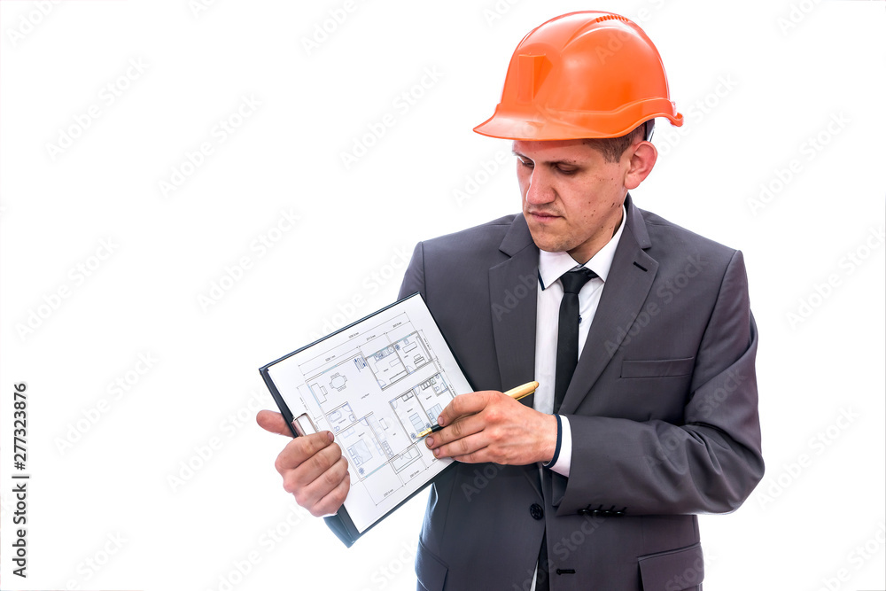 Man in helmet pointing with pen at clipboard Man in helmet pointing with pen at clipboard