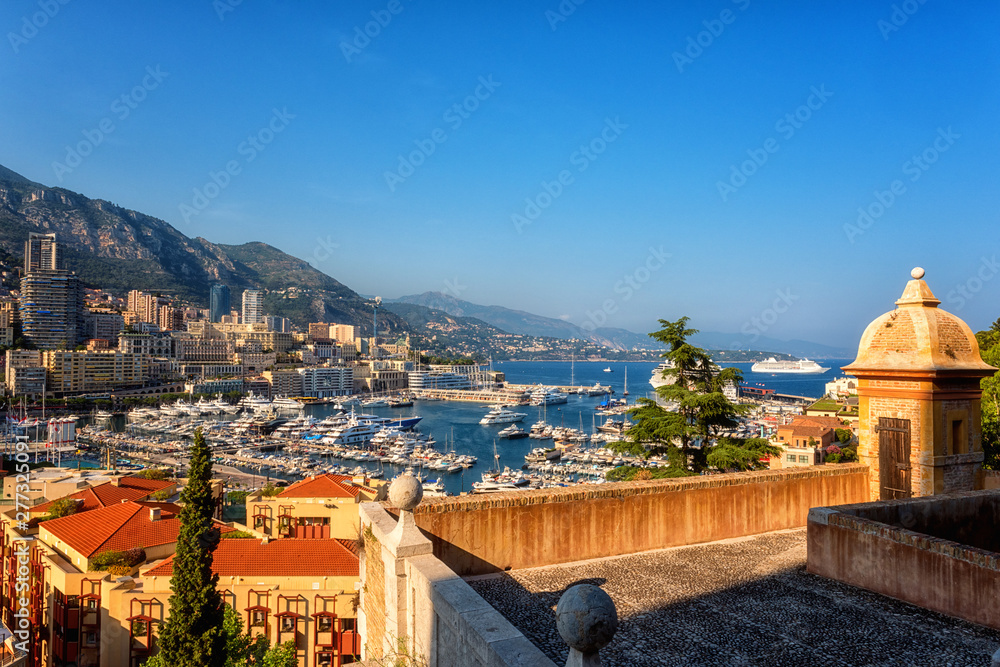 Panoramic view of Monaco harbor, Monte Carlo. Scenic summer cityscape with buildings, mountains, luxury yachts and blue sky, Cote d'Azur, microstate of the French Riviera, outdoor travel background