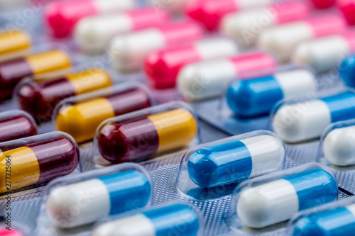 Fototapeta Selective focus on blue-white capsule pills in blister pack