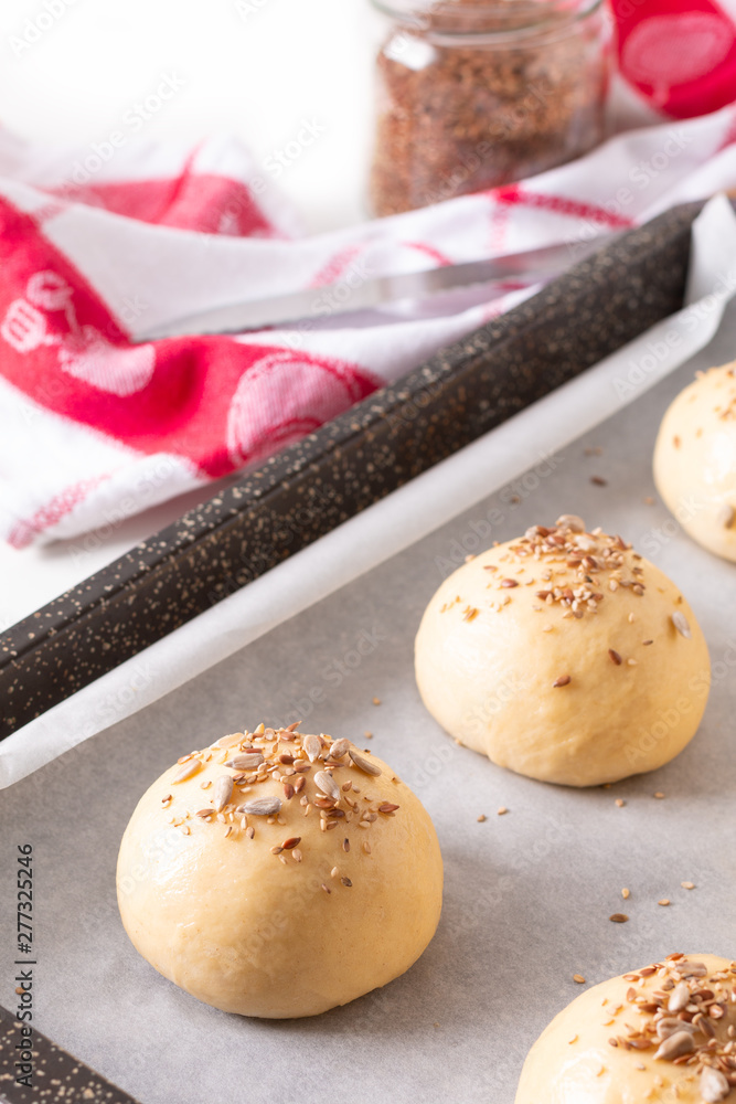 Food concept Proving, Proofing yeast dough of hamburger buns in bake pan before baking Food concept Proving, Proofing yeast dough of hamburger buns in bake pan before baking