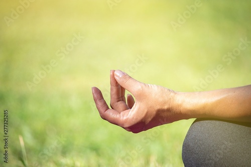 Woman is doing meditation focus at hand © thaninee