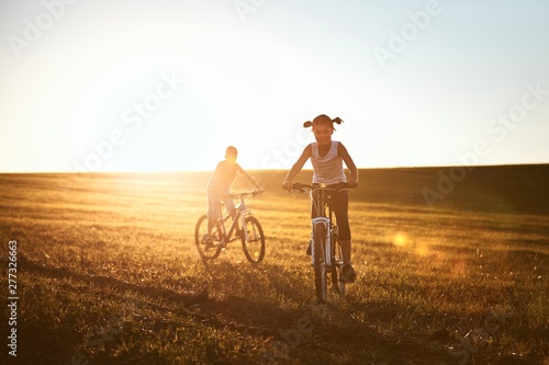Girl and boy enjoying bike ride