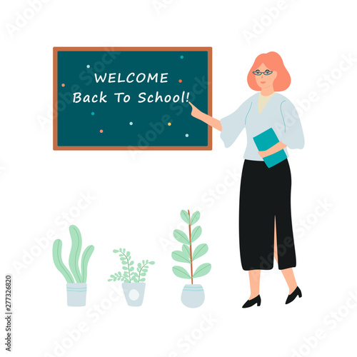 Female teacher standing at the blackboard with welcome