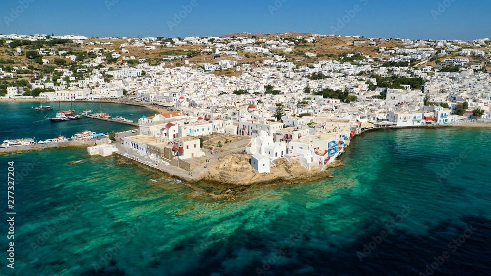 Aerial drone photo of popular landmark chapel of Paraportiani with beautiful emerald colour rocky seascape next to little Venice, main town of Mykonos island, Cyclades, Greece