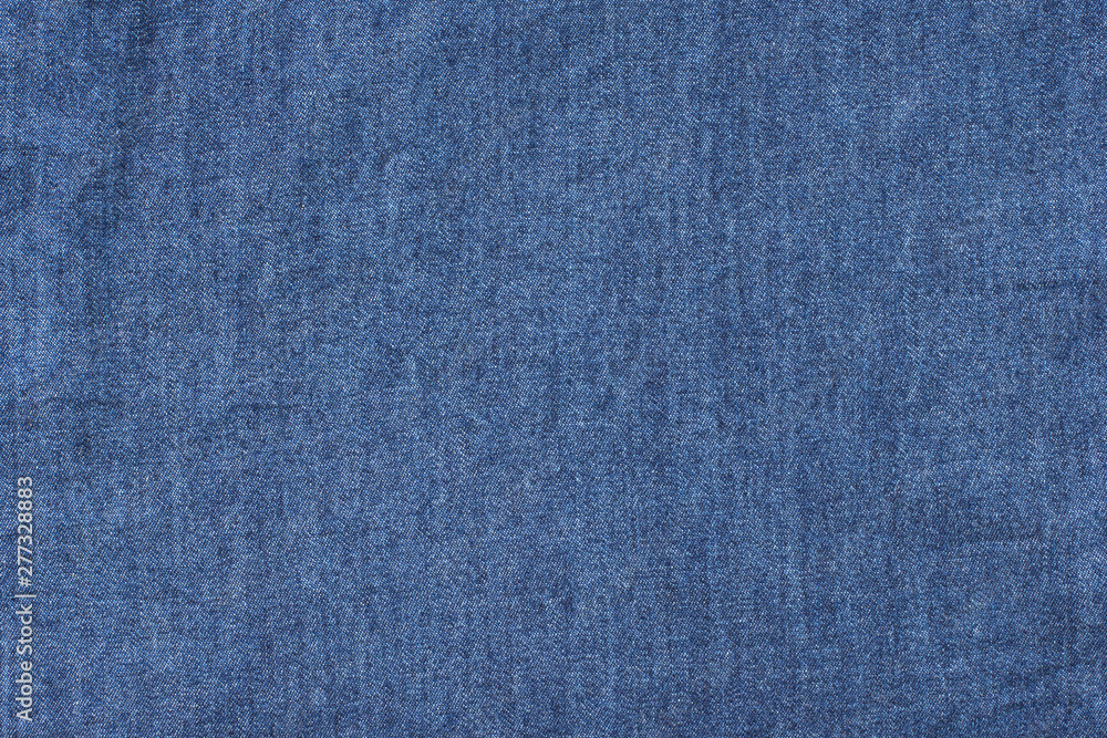 Old blue denim jeans texture or background with visible fibers Old blue denim jeans texture or background with visible fibers