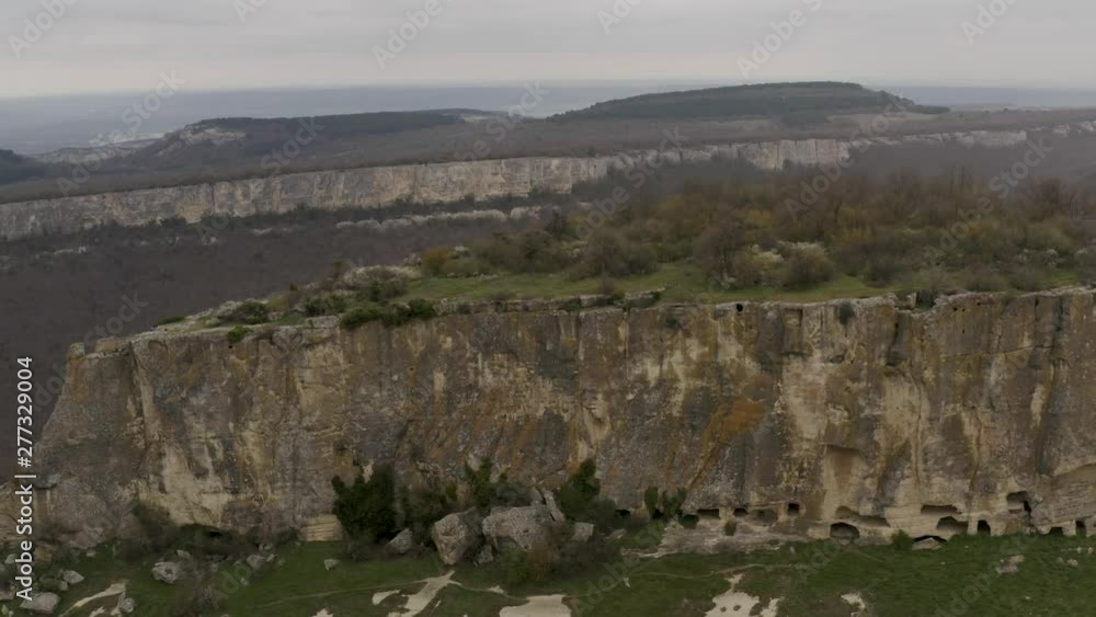 Flying drone above the cave city Tepe-Kermen, near the city of Bakhchisaray, Crimea Flying drone above the cave city Tepe-Kermen, near the city of Bakhchisaray, Crimea