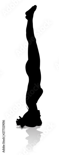 A silhouette of a woman in a yoga or pilates pose