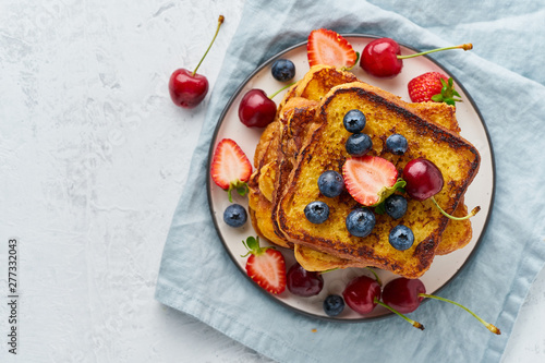 French toasts with berries, brioche breakfast, white background top view copy space