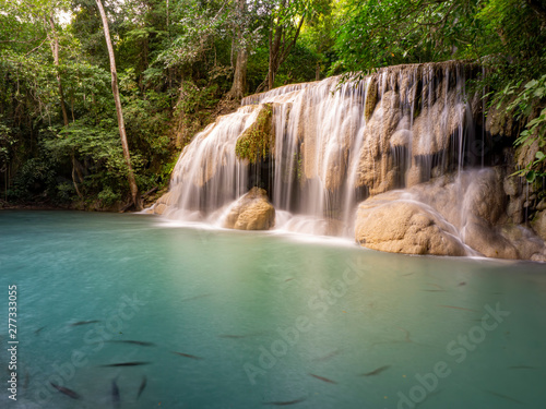 Clean green emerald water from the waterfall Surrounded by small trees - large trees   green colour   fish live in the pond  Erawan waterfall  Kanchanaburi province  Thailand