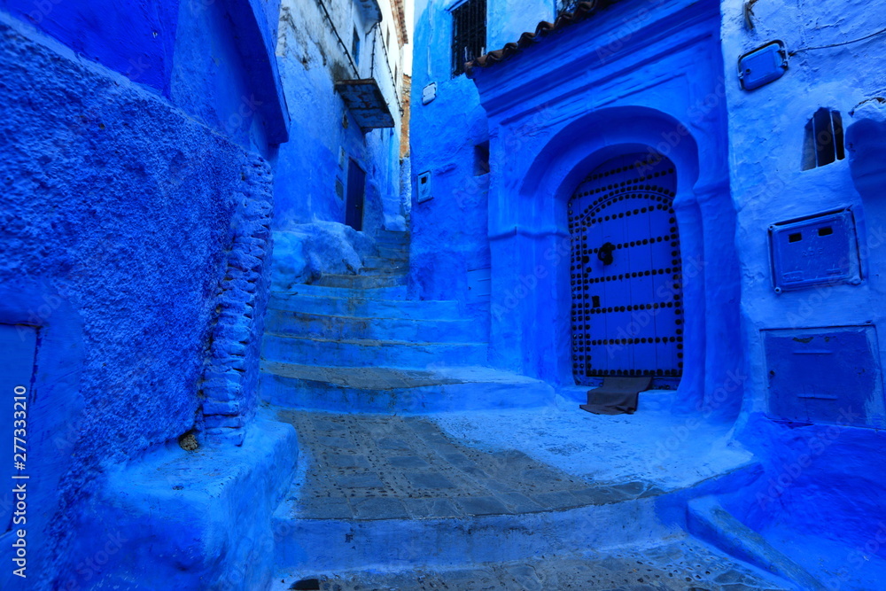 Blue street walls of the popular city of Morocco, Chefchaouen. Traditional moroccan architectural details.