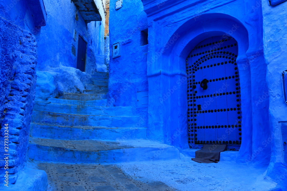 Blue street walls of the popular city of Morocco, Chefchaouen. Traditional moroccan architectural details.