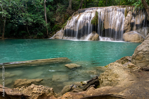 Clean green emerald water from the waterfall Surrounded by small trees - large trees   green colour  Erawan waterfall  Kanchanaburi province  Thailand