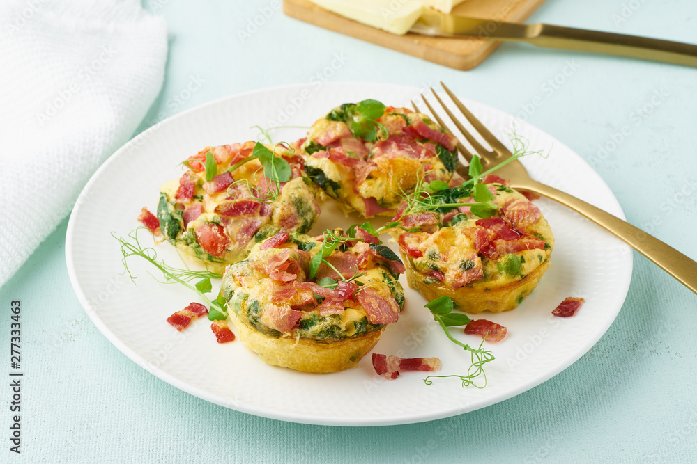 Egg muffin baked with bacon, ketogenic keto diet, pastel modern closeup Egg muffin baked with bacon, ketogenic keto diet, pastel modern closeup
