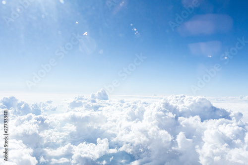 Clouds and sky from airplane window view photo