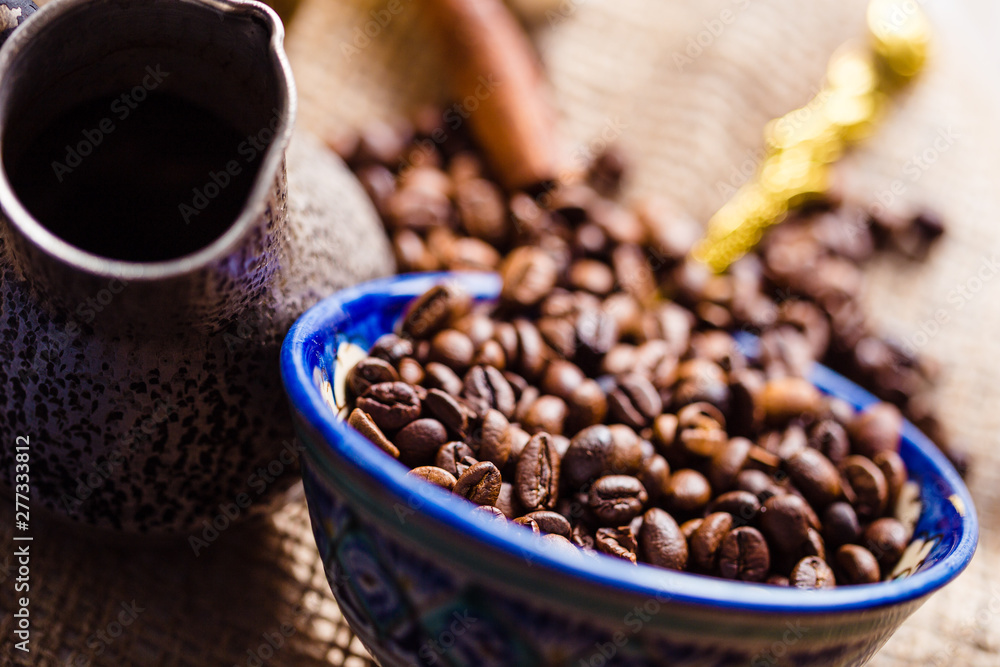 Fototapeta premium Fresh coffee in cezve on wooden table