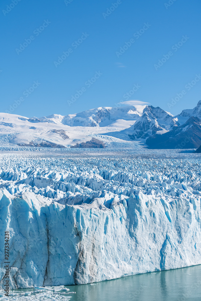 Amazing view of Perito Moreno glacier, blue ice burg glacier from peak of the mountain through the aqua blue lake in Los Glaciares National Park, Santa Cruz, Argentina, southern Patagonia ice field Amazing view of Perito Moreno glacier, blue ice burg glacier from peak of the mountain through the aqua blue lake in Los Glaciares National Park, Santa Cruz, Argentina, southern Patagonia ice field