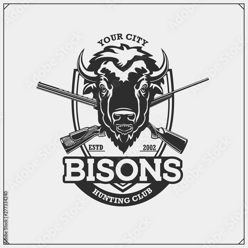 Hunting club emblem with bison and crossed rifles.