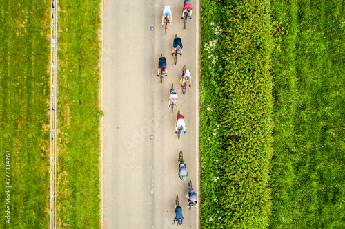 Cyclist racing through the countryside, aerial view