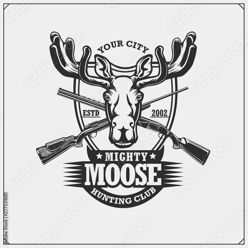 Hunting club emblem with moose or elk and crossed rifles.