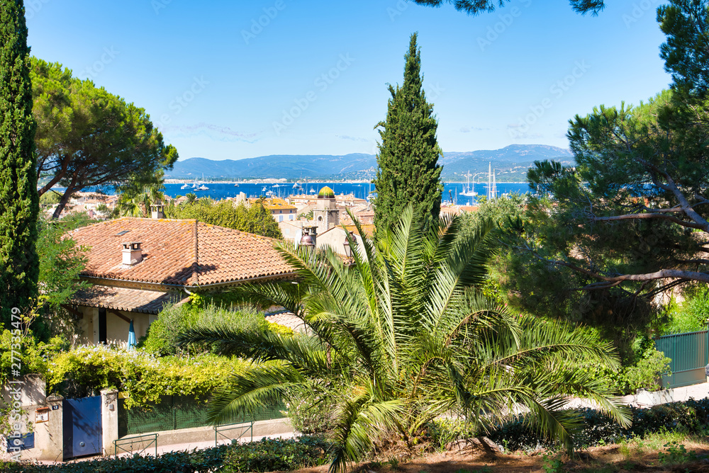 View of the hill on Saint-Tropez, the roofs of houses, yachts in the bay. Commune in southeastern France in the region of Provence, Alpes - Cote d'Azur, France