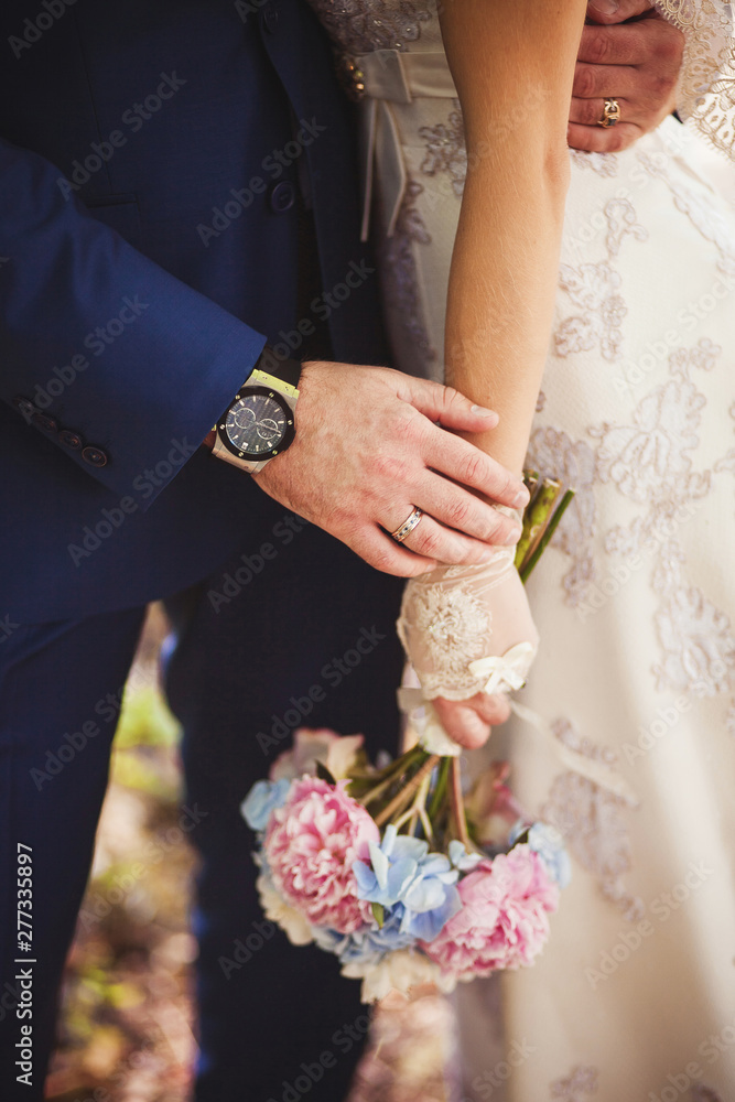 Wedding bouquet in pink and blue in the hands of the bride Wedding bouquet in pink and blue in the hands of the bride