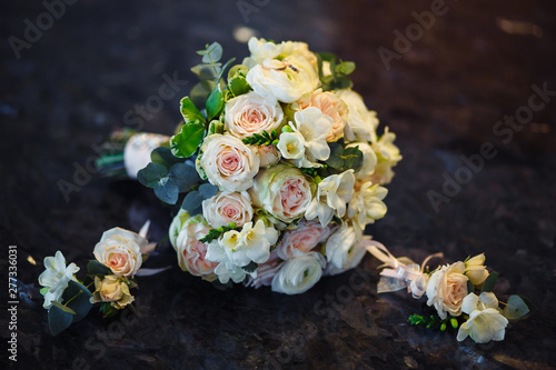 Wedding bouquet of the bride and boutonniere groom