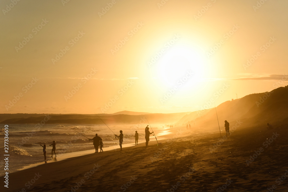 Fototapeta premium Family Fishing On A Sunset Afternoon Beach, Mossel Bay, South Africa