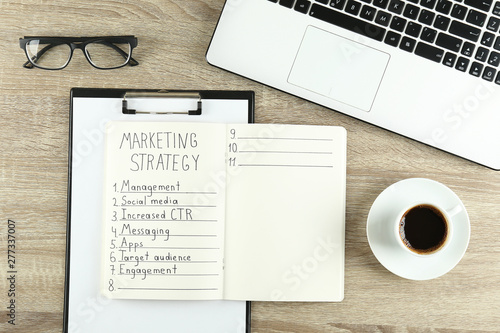 Digital marketing strategies concept. Hand written marketing plan. Close up  copy space  top view  flat lay  background.