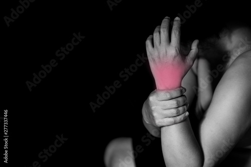 woman holding her wrist symptomatic Office Syndrome