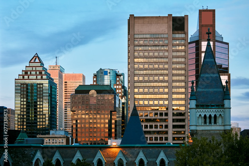Cityscape of Montreal, Canada. The dome of presbyterian catholic collage and skyscraper buildins at sundown.