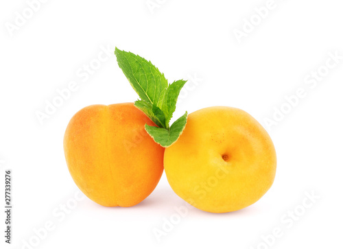 Apricot with a sprig of mint on a white background