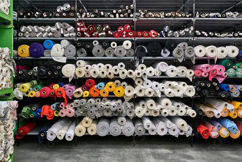 Fabric warehouse with many multicolored textile rolls