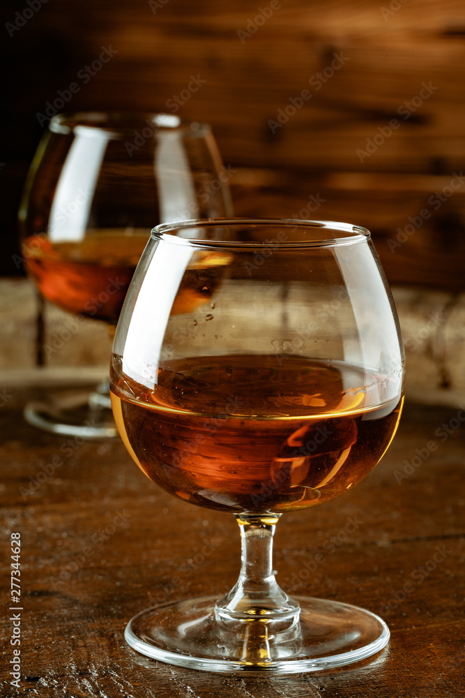 Two glasses of whiskey on a wooden table in the bar Two glasses of whiskey on a wooden table in the bar