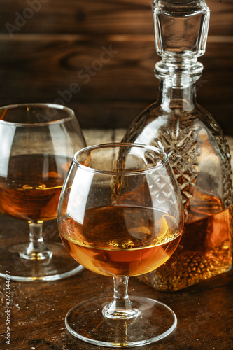 Cognac or whiskey in glasses on rustic backgrpund