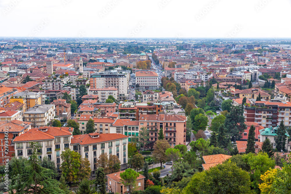 Aerial view of Bergamo city, Lombardy, Italy. Central street Viale Roma and Bergamo Central Railway station in the end of the street on background