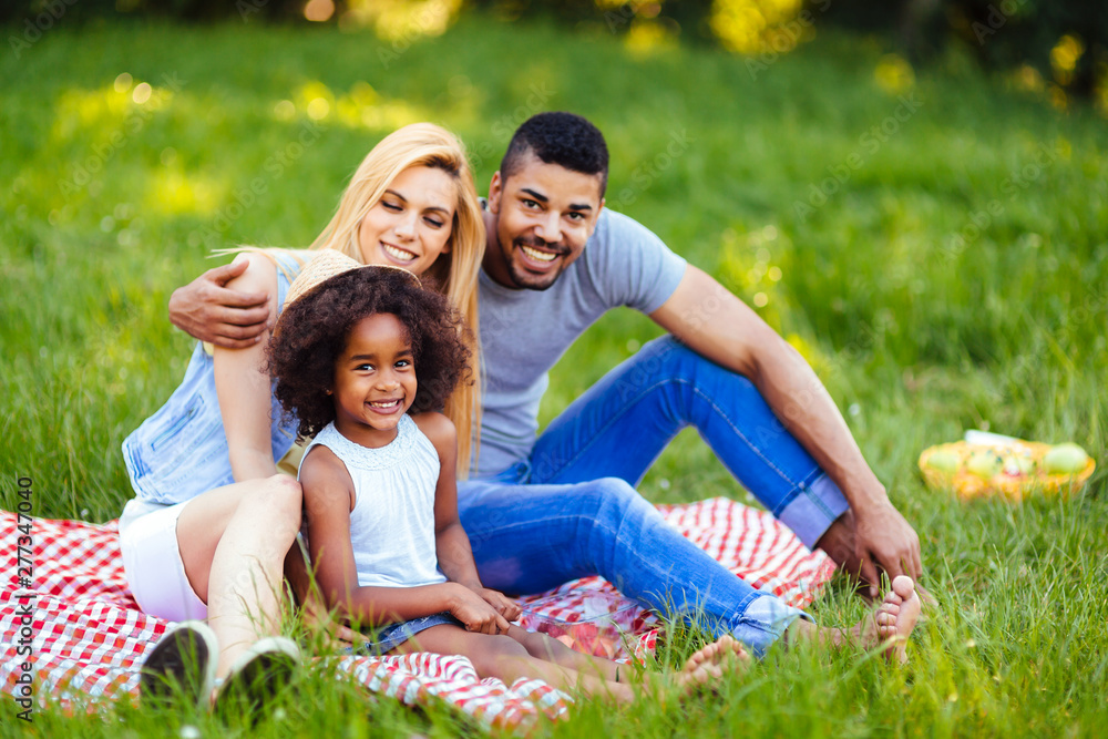 Picture of lovely couple with their daughter having picnic Picture of lovely couple with their daughter having picnic