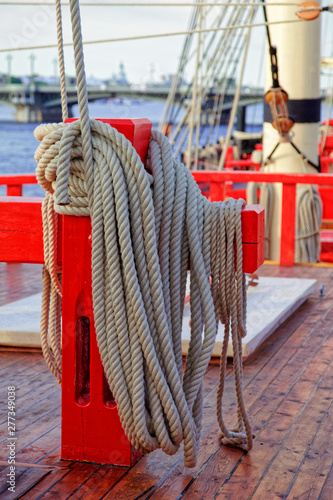 Close up of a rope on a old wooden ship. Details deck of the saiilboat photo